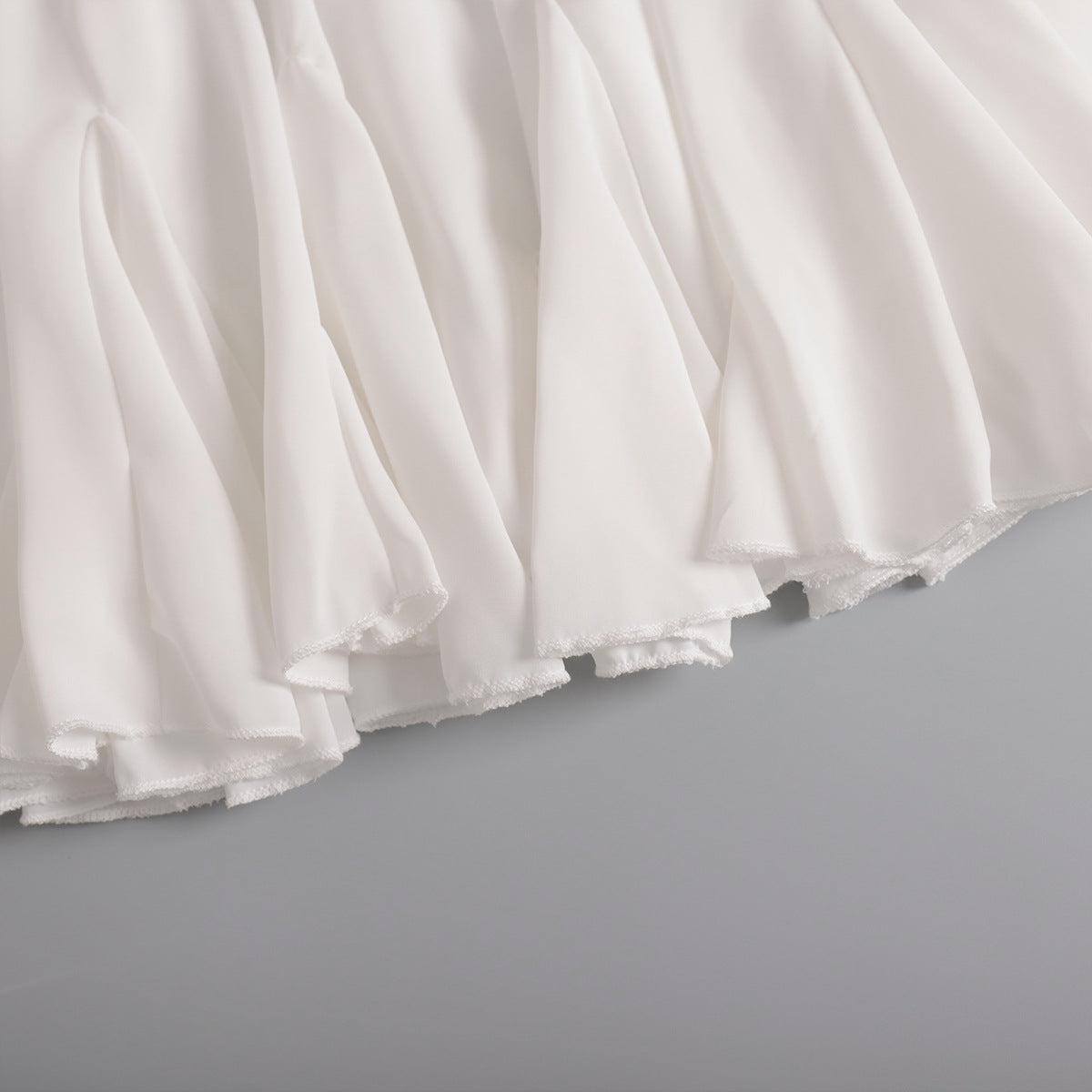 Pleated Bubble Mini Skirt in White — close-up of fabric