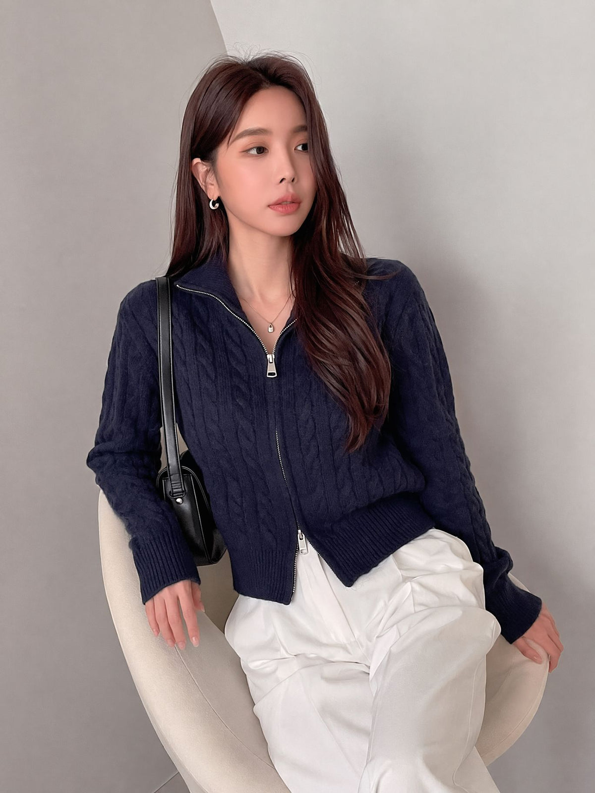 Cable-Knit Zip-Up Cardigan Sweater in Navy — front view on model