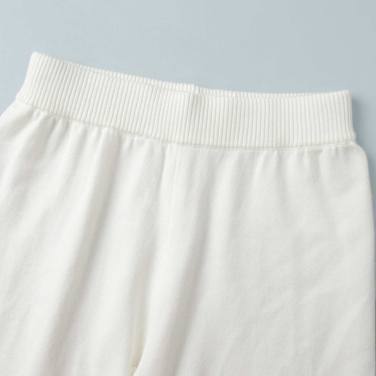 Wide-Collar Zip-Up Knit Cardigan & Wide-Leg Pants Set in Ivory — close-up of the pants waistband