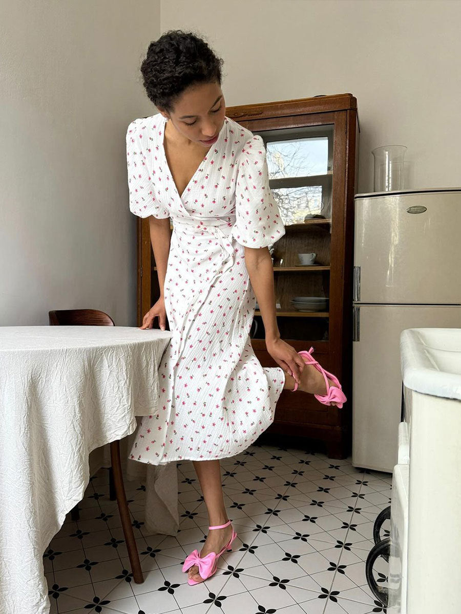 Cotton Floral Puff-Sleeve Wrap Midi Dress in Yellow Floral — indoor side on model