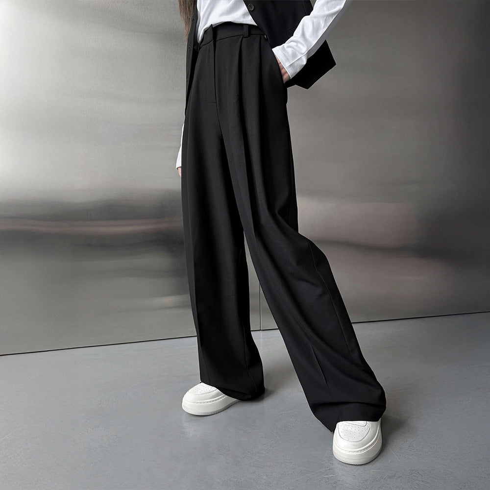 Pleated Wide-Leg Trousers in Black — on model, front view