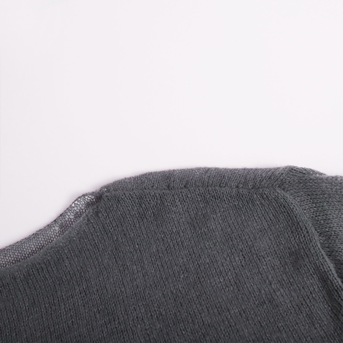 Sheer Open-Knit Bell Sleeve Sweater in Charcoal — close-up of hem