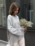 Oversized Open-Back Cotton Knit Sweater in Light Gray — front view on model