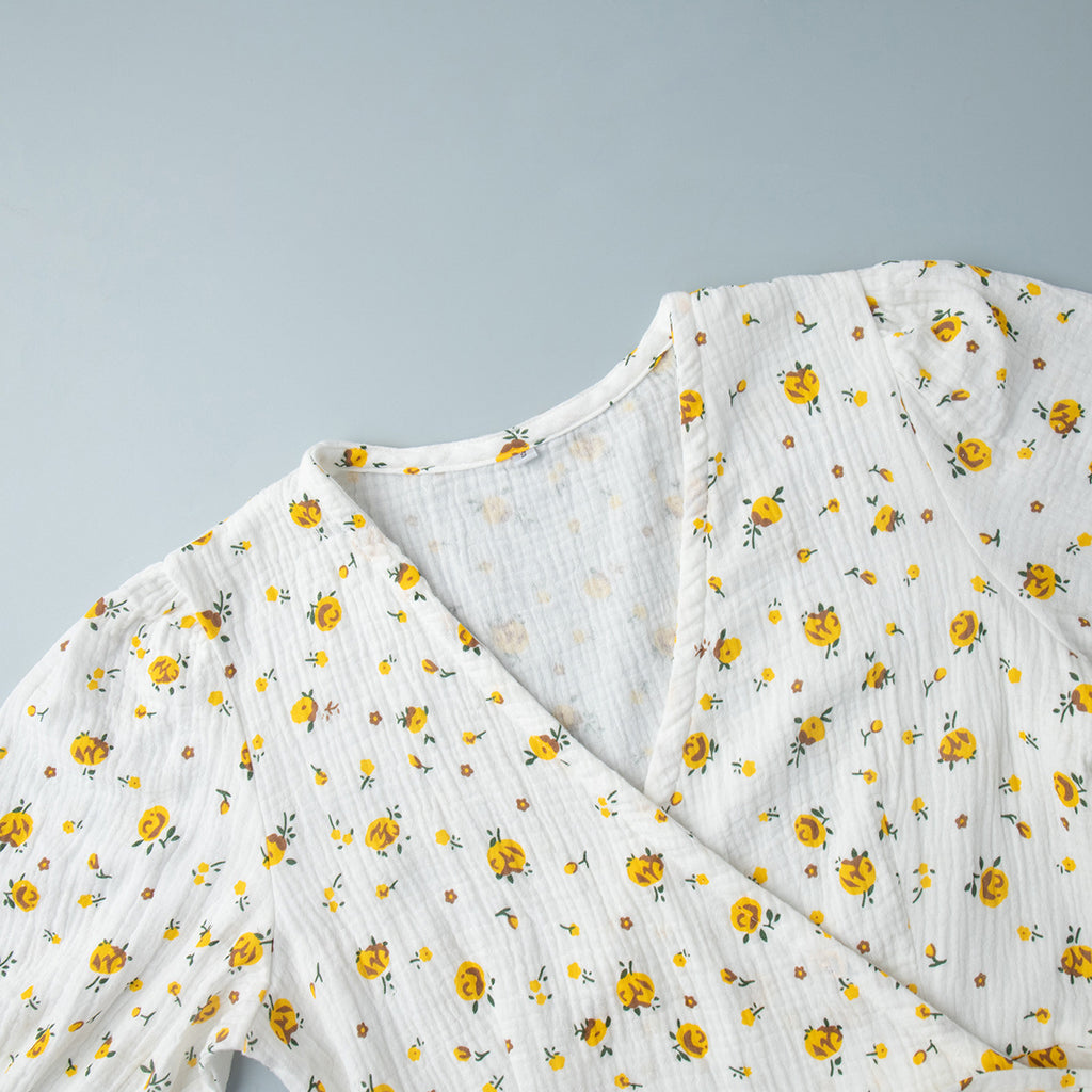Cotton Floral Puff-Sleeve Wrap Midi Dress in Yellow Floral — close-up of the V neckline
