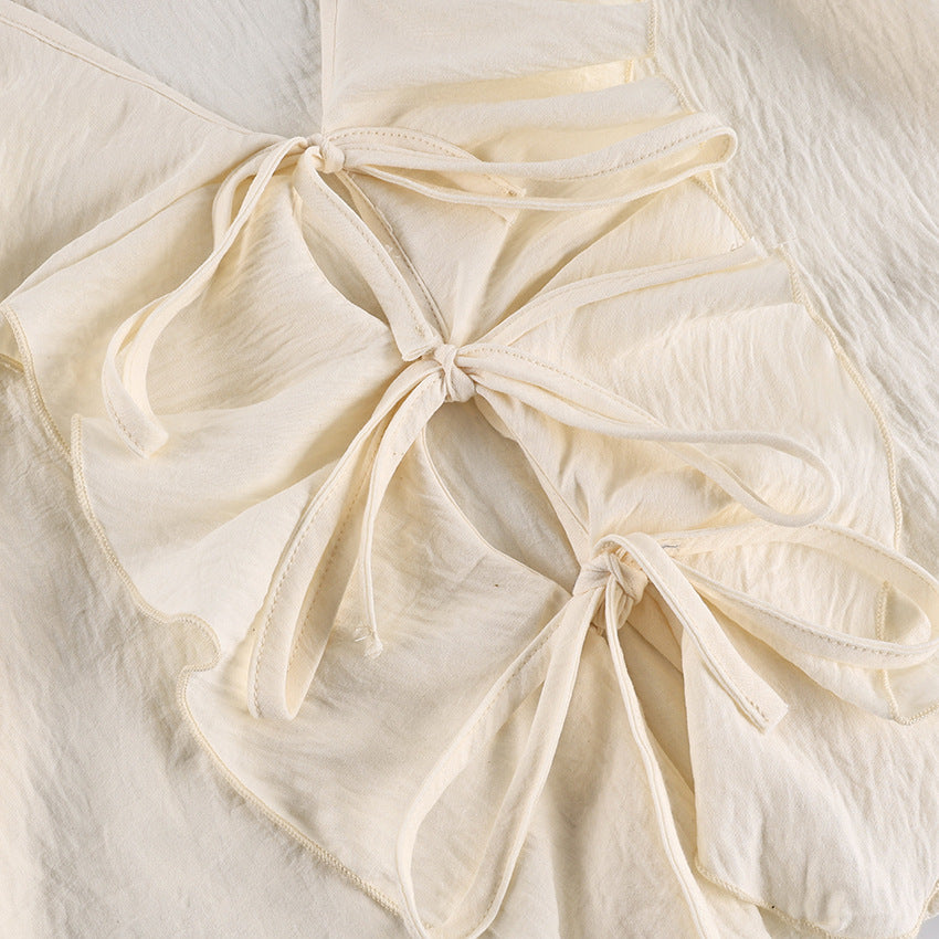 Ruffle Tie-Front Blouse and Wide-Leg Pants Set in Cream — close-up of the tie front