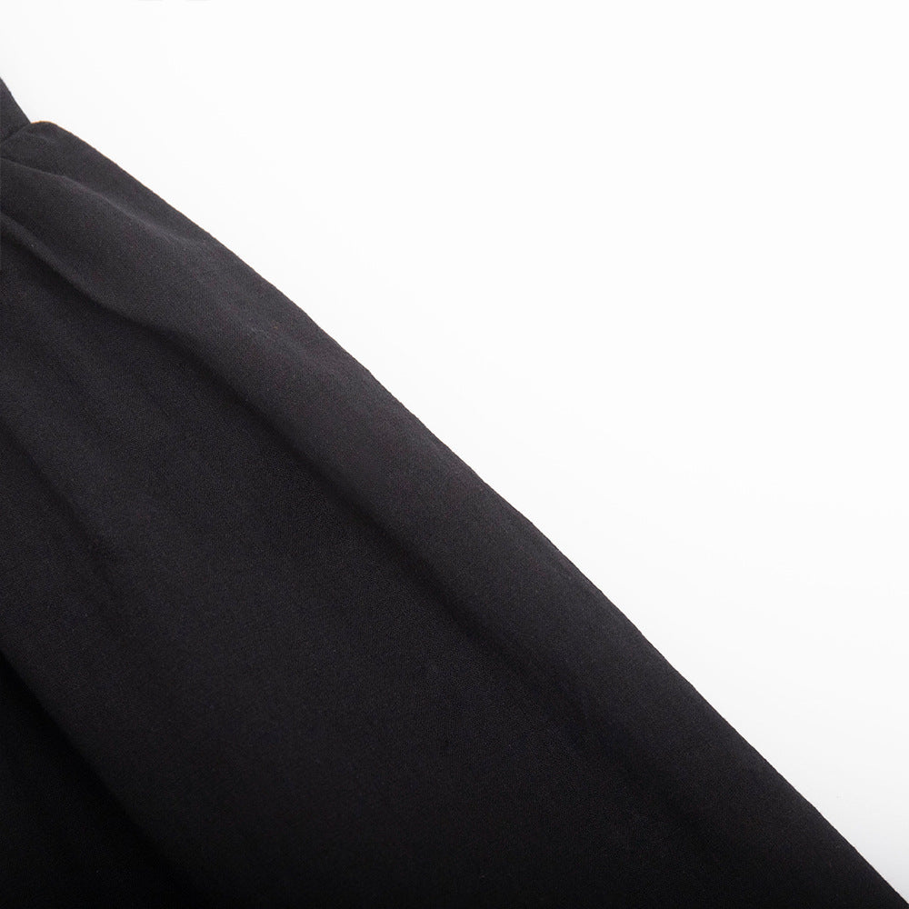 Tie-Shoulder Open-Back Cotton Mini Dress in Black — close-up of fabric texture