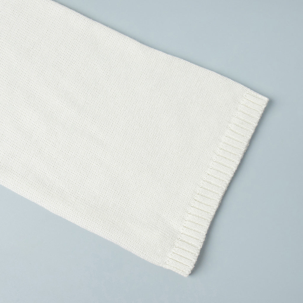 Oversized Open-Back Cotton Knit Sweater in Cream — close-up of the ribbed cuff
