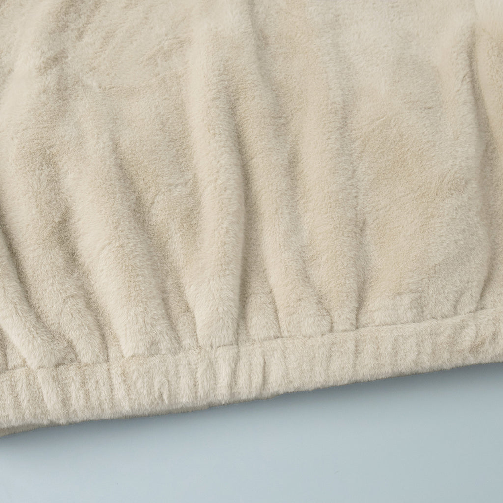 Plush Faux Fur Zip-Up Jacket with Stand Collar in Cream — close-up of the gathered hem