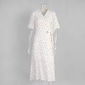 Cotton Floral Puff-Sleeve Wrap Midi Dress in Pink Floral — front on mannequin