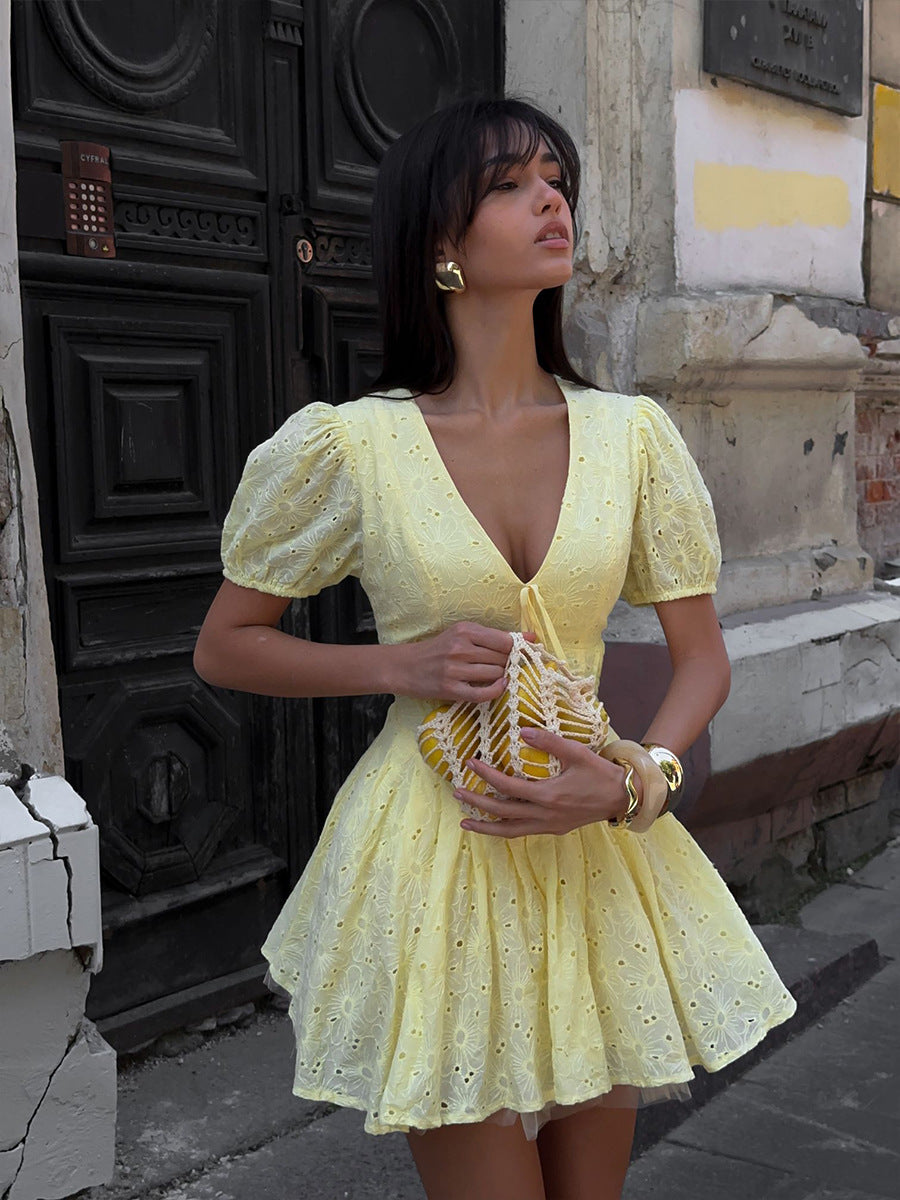 Yellow Eyelet Puff-Sleeve Mini Dress in Pale Yellow — on model outdoors