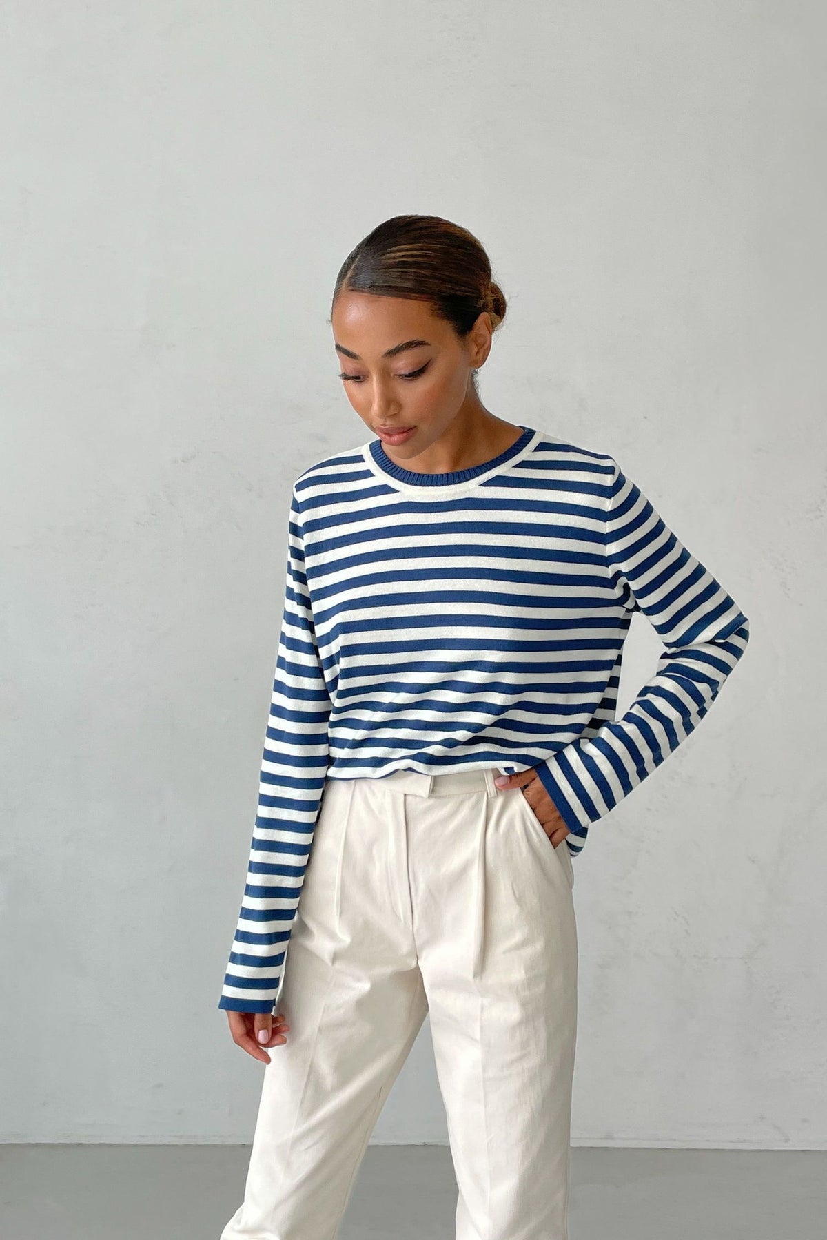 Relaxed Striped Crew Neck Sweater in Blue Stripe — front view on model with cream trousers