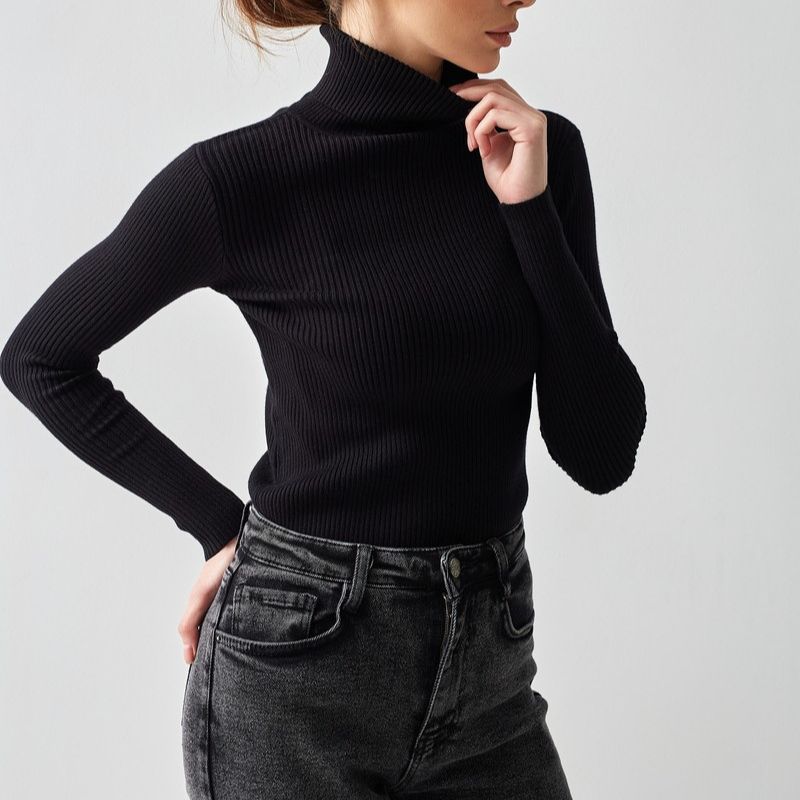 Fitted Ribbed Turtleneck Sweater in Black — front view on model