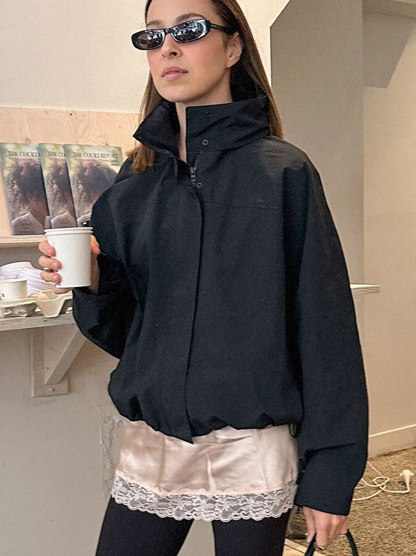Oversized Stand-Collar Nylon Jacket with Drawcord Hem in Black — on model, zipped to the collar