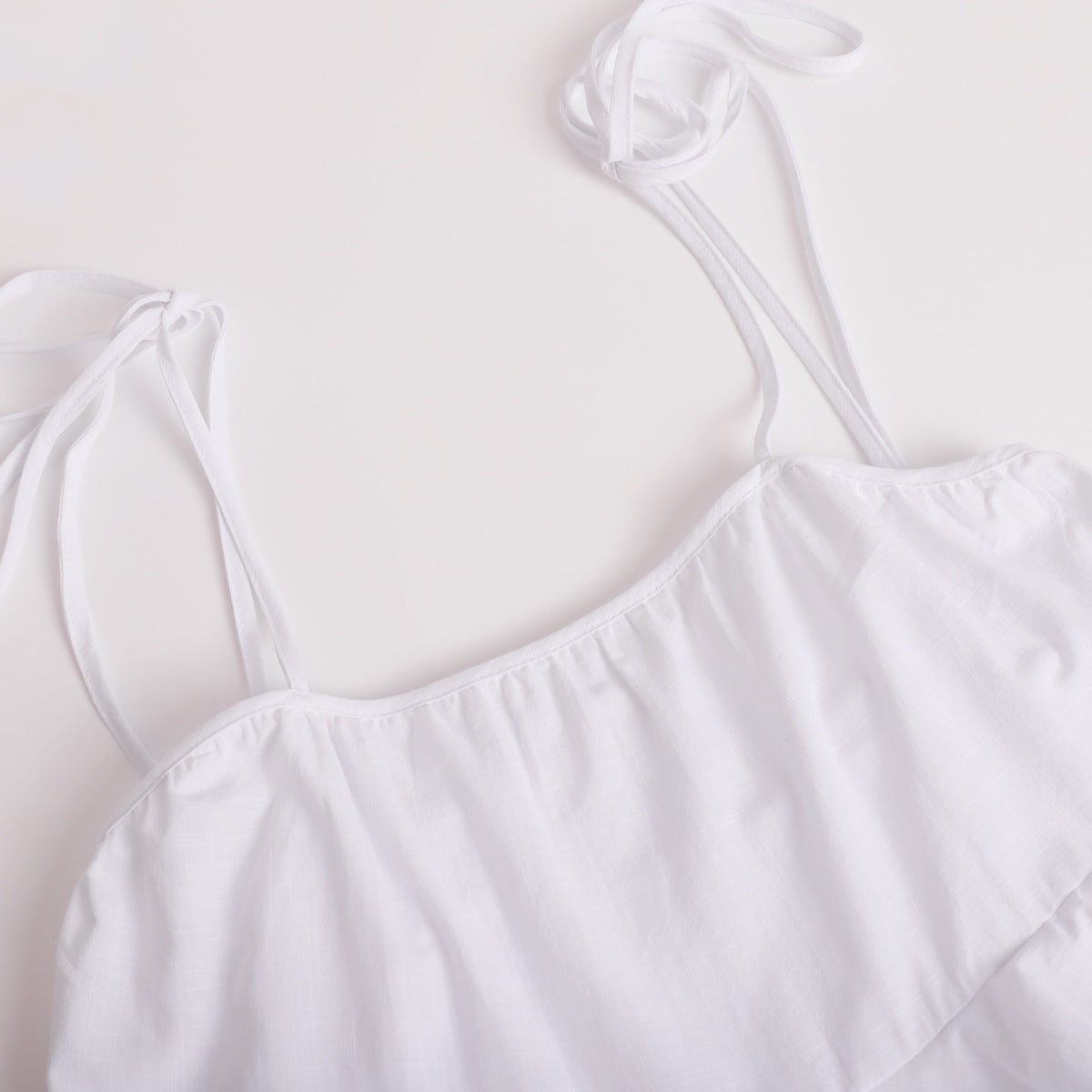 Tiered Ruffle Tie-Strap Mini Dress in White — close-up of the neckline and ties