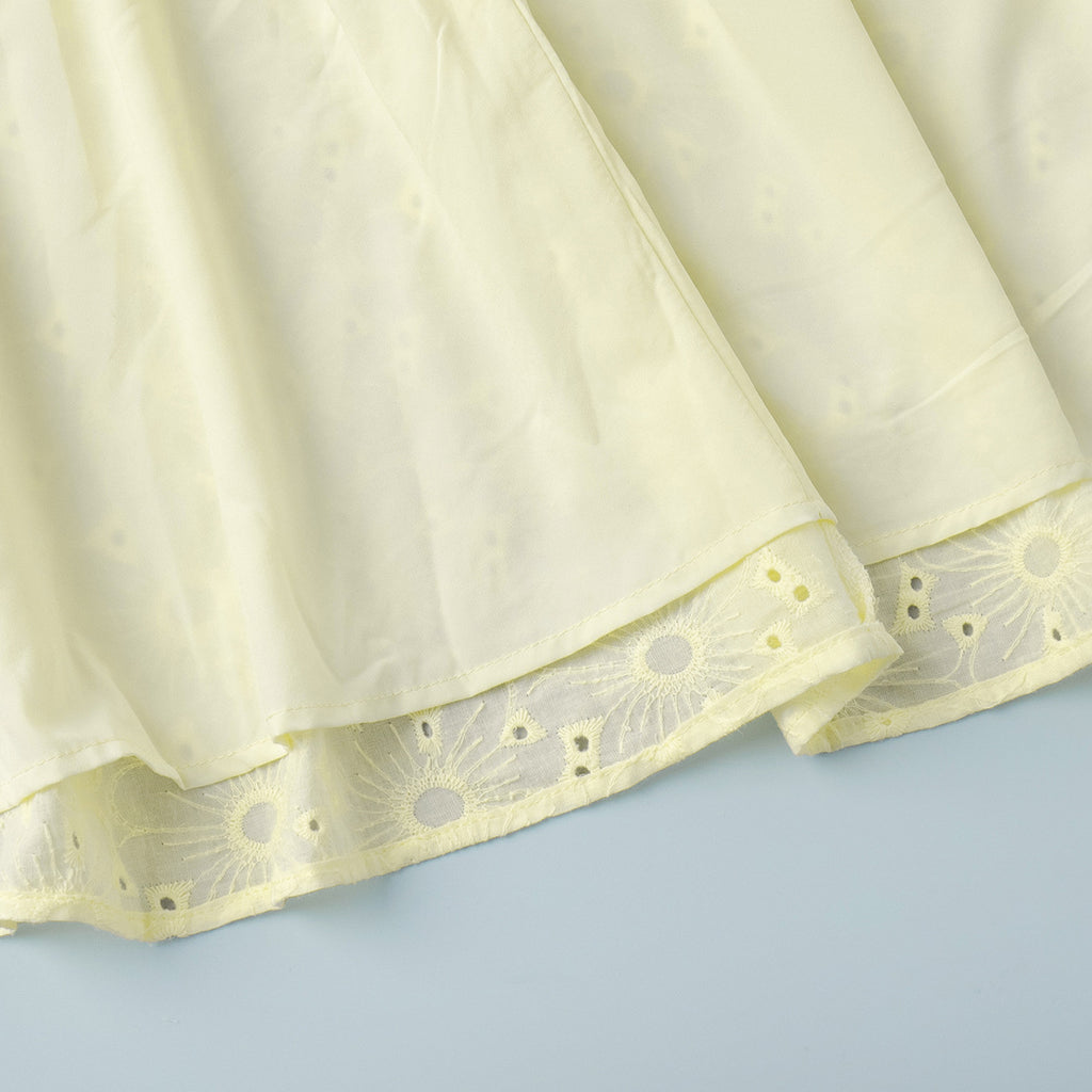 Yellow Eyelet Puff-Sleeve Mini Dress in Pale Yellow — close-up of the eyelet fabric