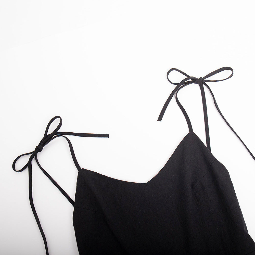 Tie-Shoulder Open-Back Cotton Mini Dress in Black — close-up of tie straps and V-neck