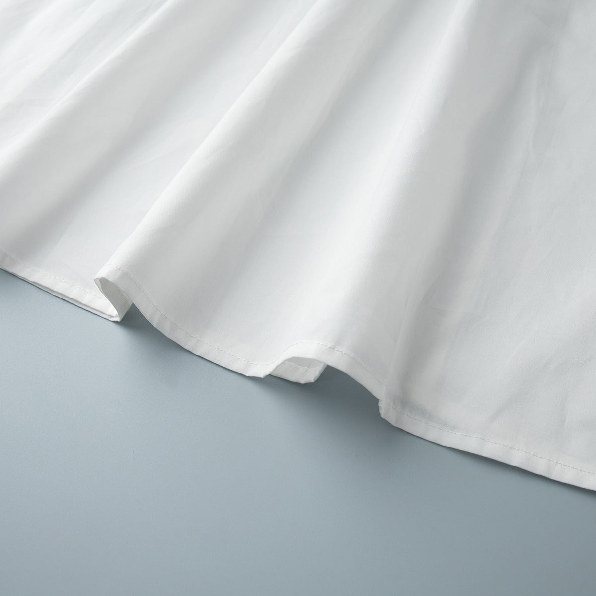 Cotton Crop Camisole & Gathered Maxi Skirt Set in White — close-up of the skirt hem