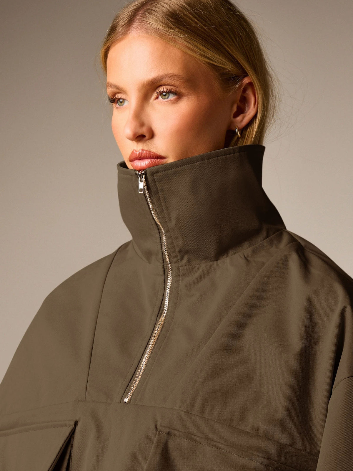 Oversized Half-Zip Funnel-Neck Windbreaker Jacket in Olive Brown — close-up of the funnel neck and zip