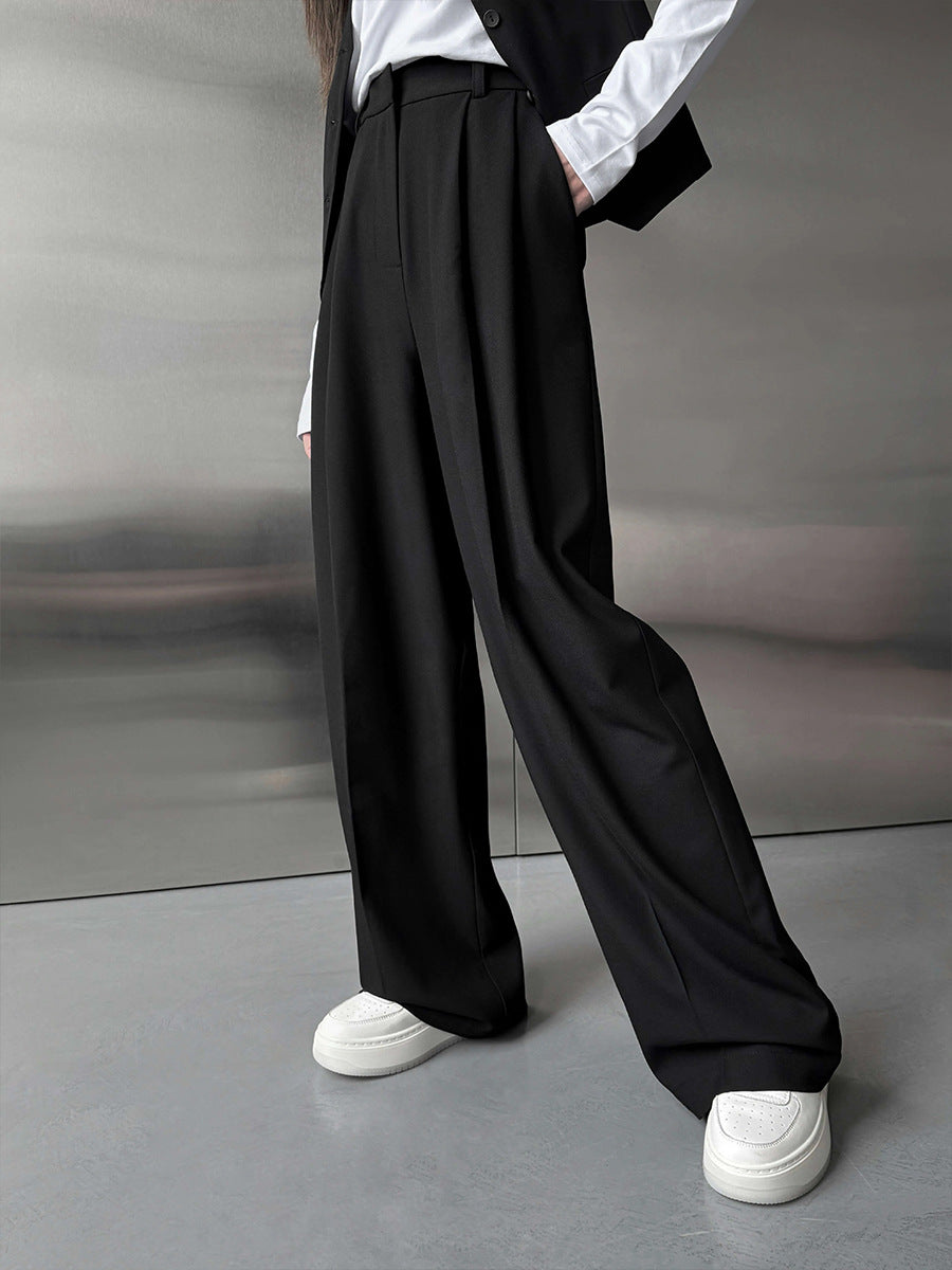 Pleated Wide-Leg Trousers in Black — on model, full length
