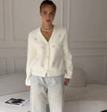 Soft Bow-Embellished V-Neck Cardigan in Ivory — front view on model