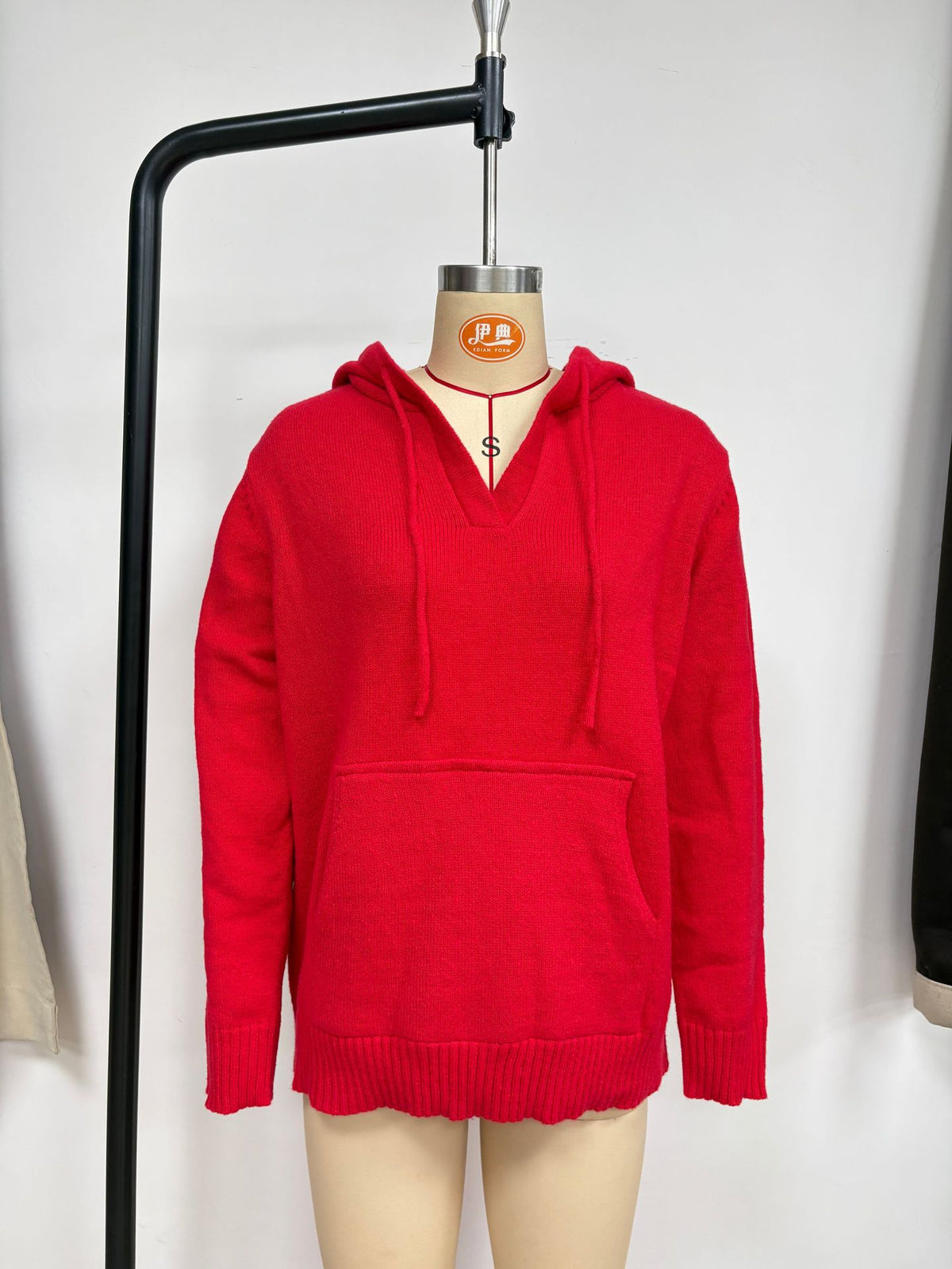 V-Neck Knit Hoodie Sweater with Kangaroo Pocket in Red — front view on a dress form