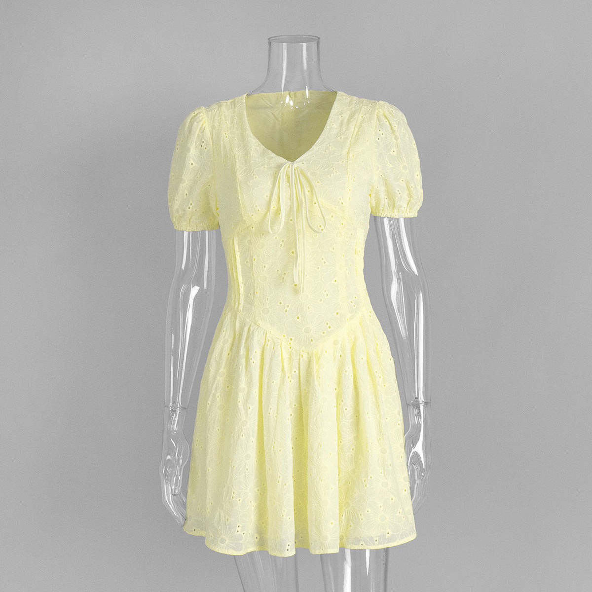 Yellow Eyelet Puff-Sleeve Mini Dress in Pale Yellow — front view on mannequin