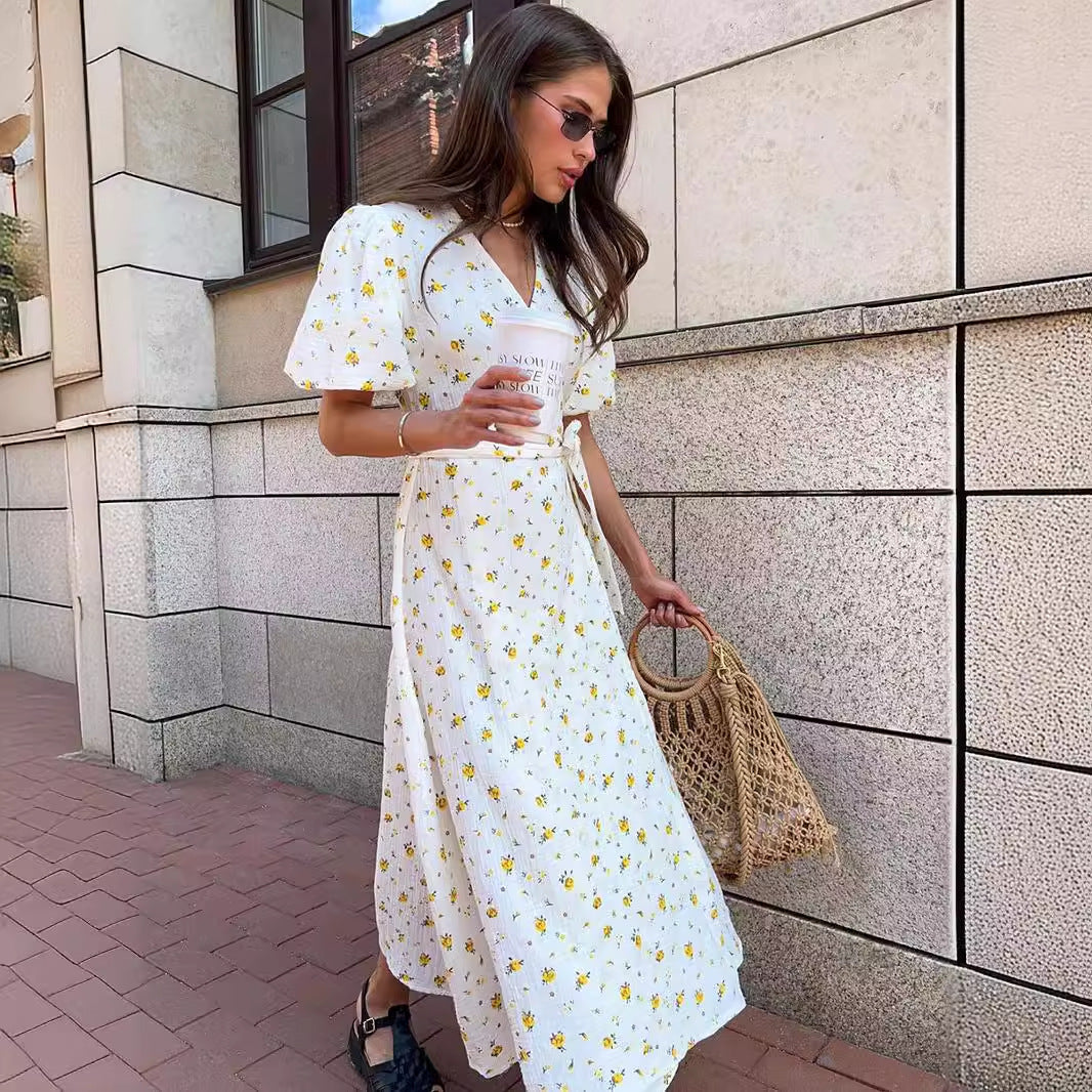 Cotton Floral Puff-Sleeve Wrap Midi Dress in Yellow Floral — front view on model, outdoor