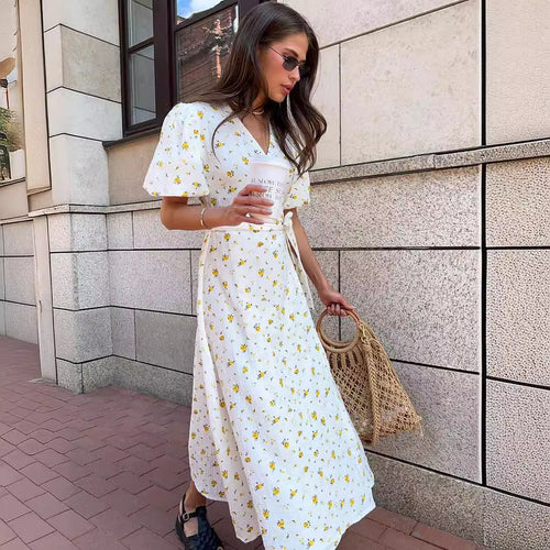 Cotton Floral Puff-Sleeve Wrap Midi Dress in Yellow Floral — front view on model, outdoor