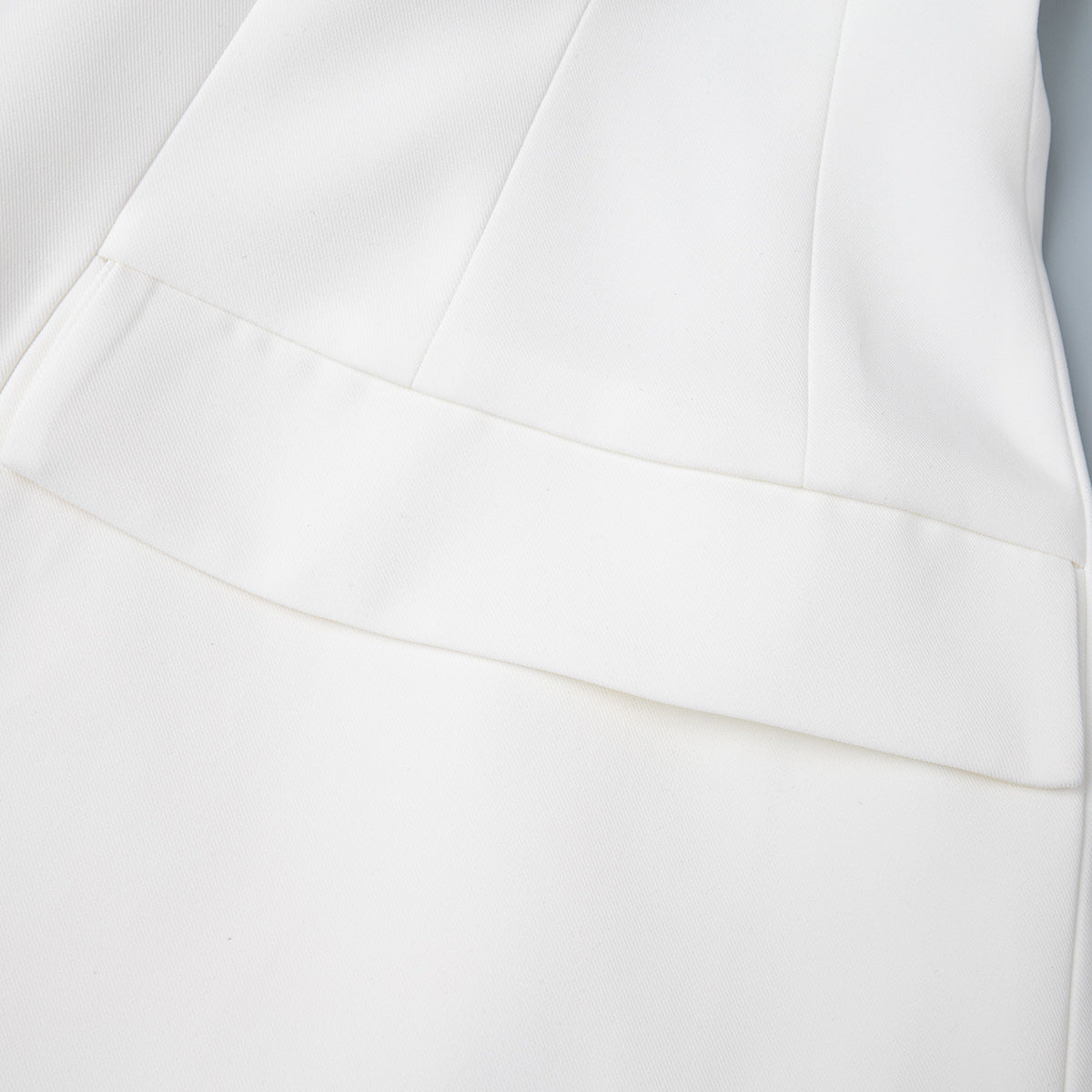 Tailored Two-Button Blazer with Cinched Waist in Ivory — close-up of the flap pocket