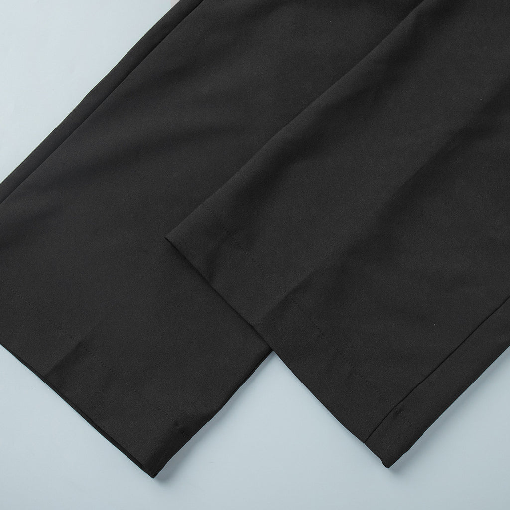 Pleated Wide-Leg Trousers in Black — close-up of hem