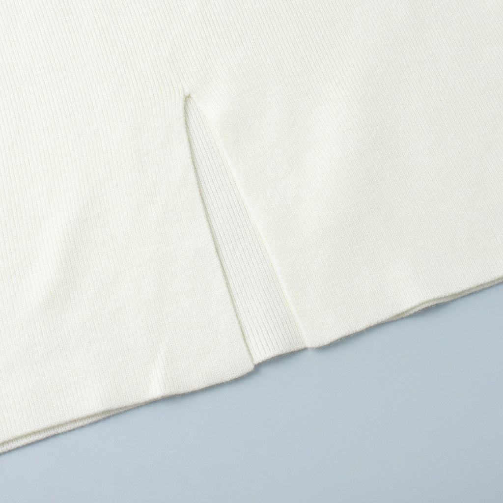 Oversized Turtleneck Sweater & Knit Maxi Skirt Set in Ivory — close-up of the skirt slit