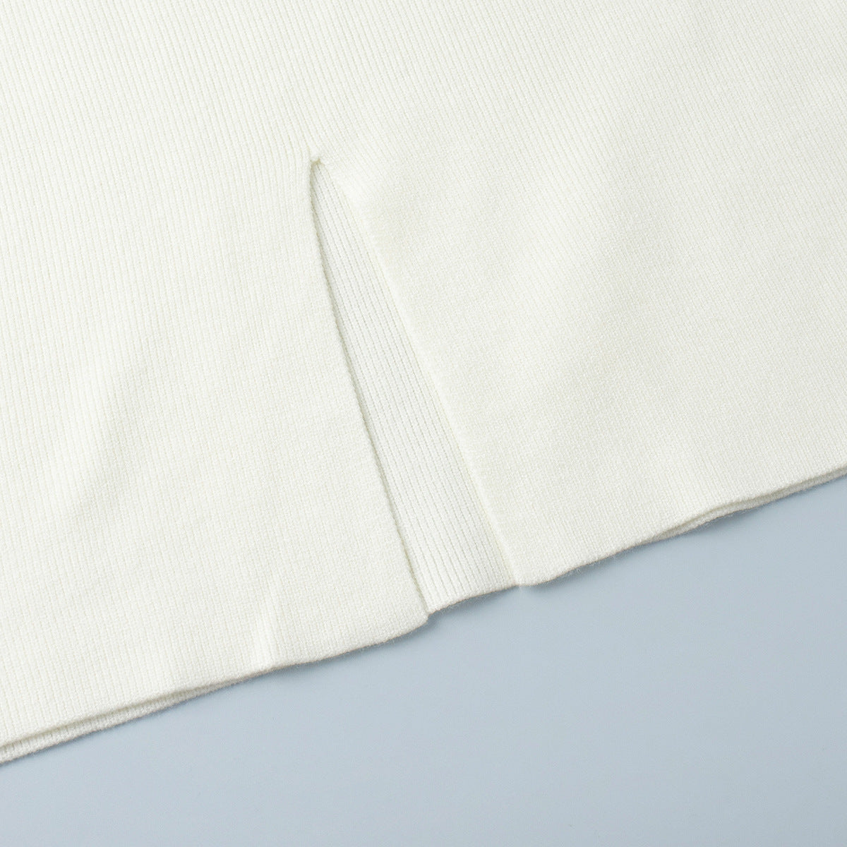 Oversized Turtleneck Sweater & Knit Maxi Skirt Set in Ivory — close-up of the skirt slit
