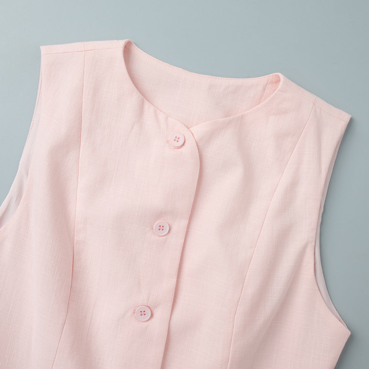 Cotton Peplum Vest & Bubble Mini Skirt Set in Soft Pink — close-up of fabric-covered buttons