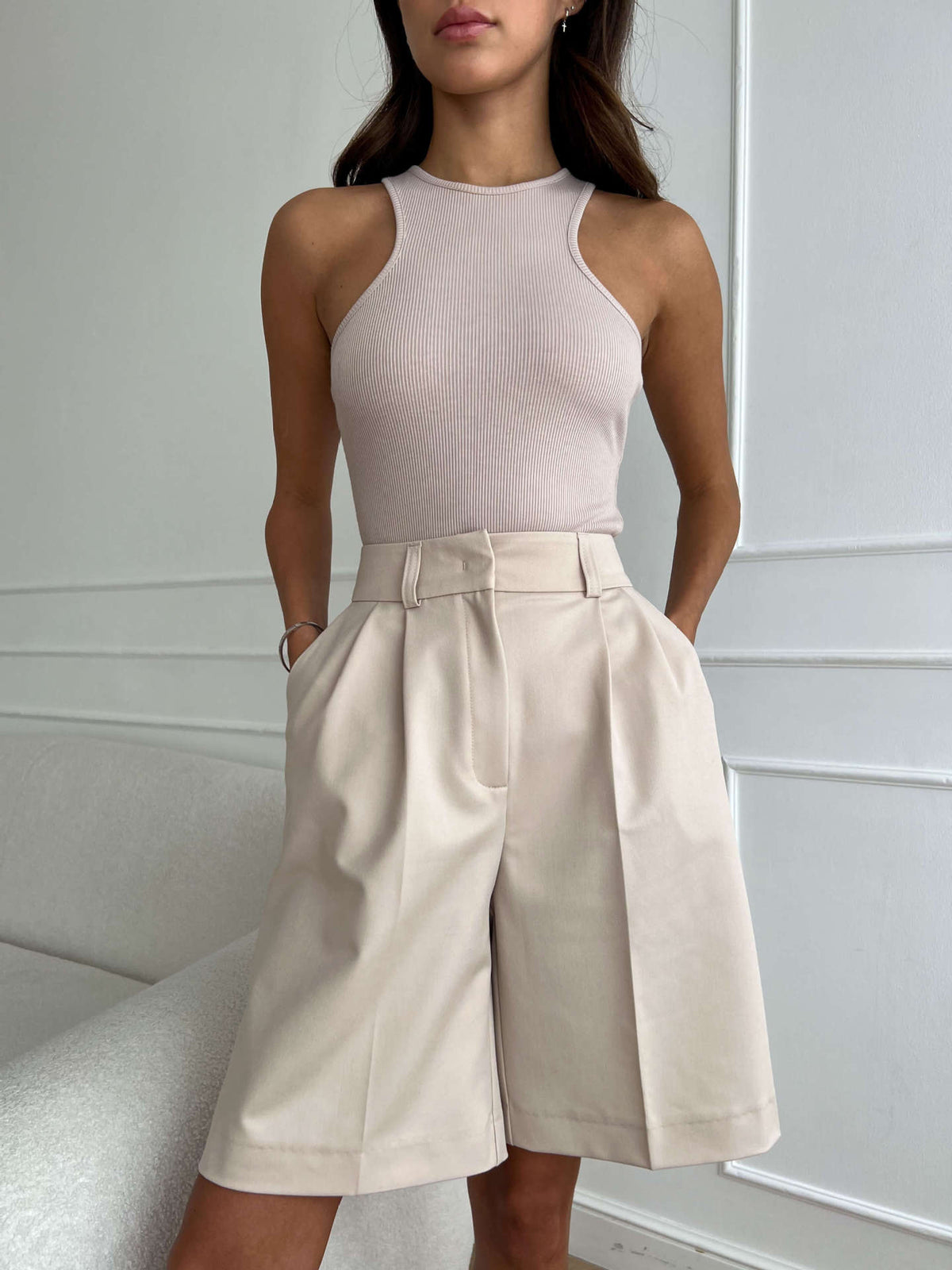 High-Waist Pleated Bermuda Shorts in Apricot — front view on model