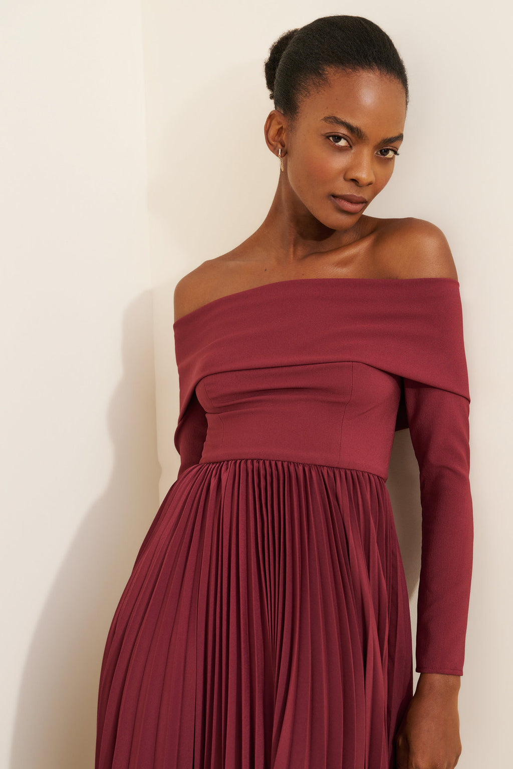 Off-the-Shoulder Long Sleeve Pleated Midi Dress in Burgundy — close-up on model