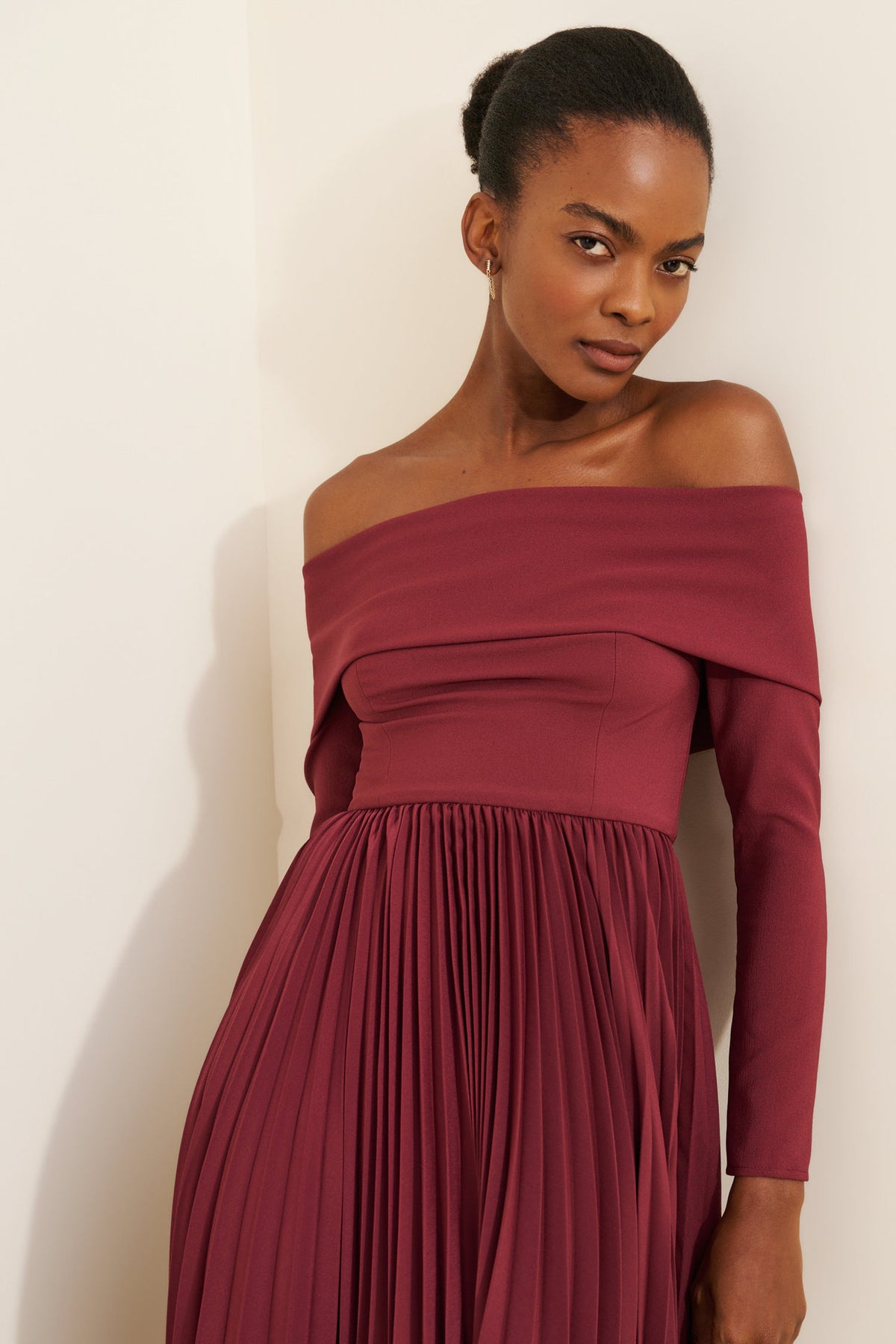 Off-the-Shoulder Long Sleeve Pleated Midi Dress in Burgundy — close-up on model