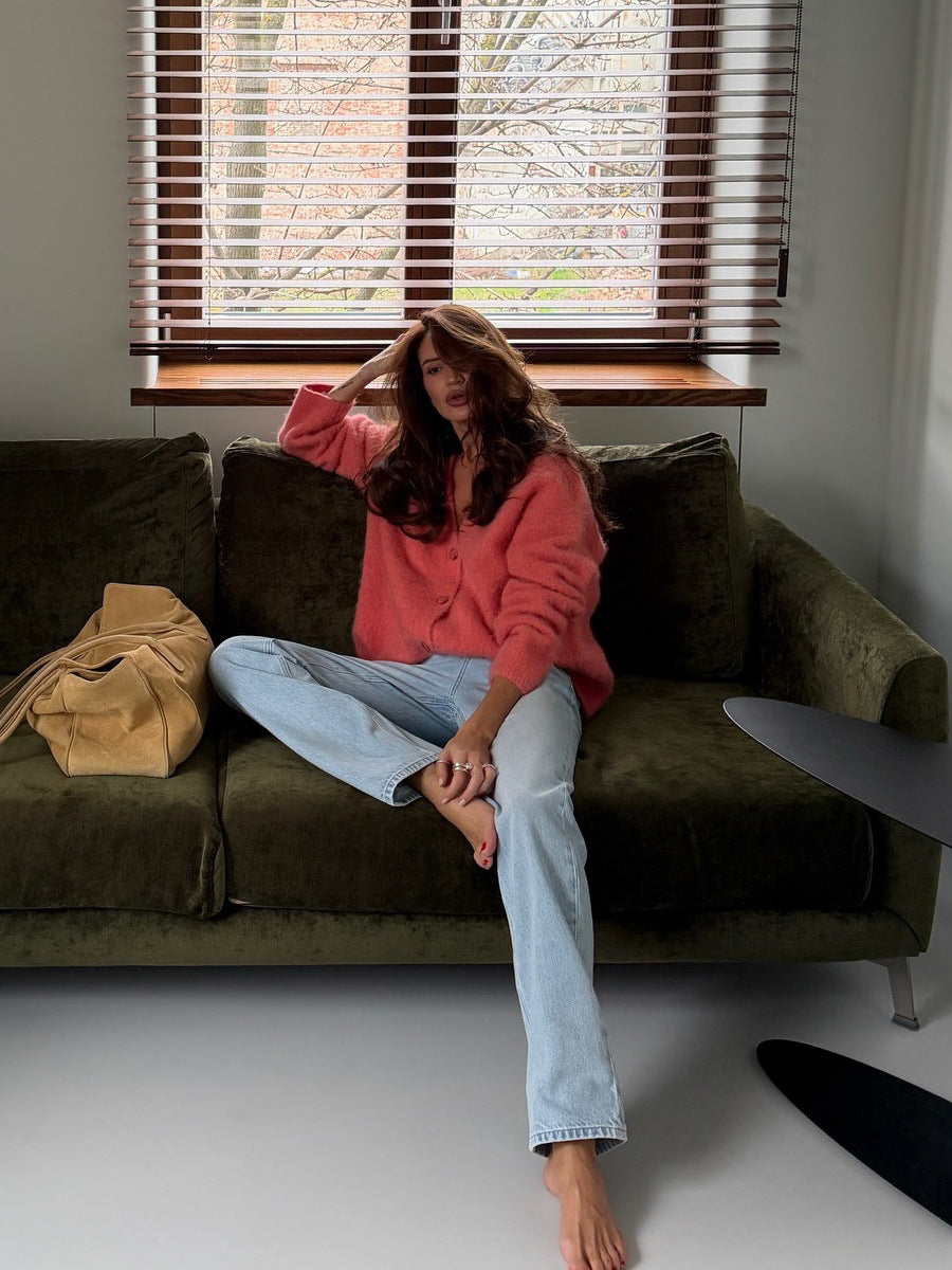 Fuzzy Wool-Blend V-Neck Button Cardigan in Coral — on model, seated on a sofa