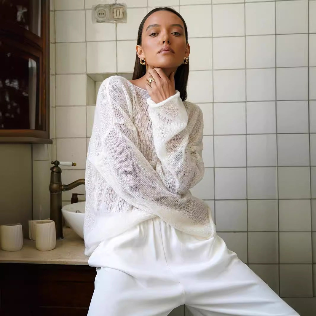 Sheer Open-Knit Bell Sleeve Sweater in White — on model lifting hem