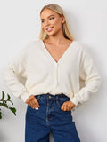 V-Neck Button Cardigan with Patch Pockets in Ivory — front view on model with jeans