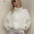 Oversized Stand-Collar Nylon Jacket with Drawcord Hem in White — front view on model with the collar up