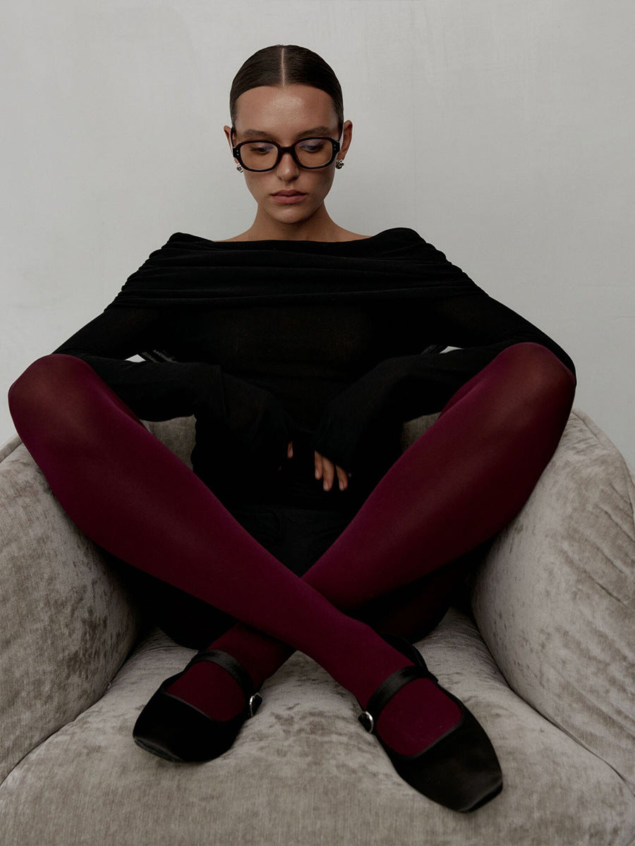 Off-Shoulder Fold-Over Knit Sweater in Black — seated view on model