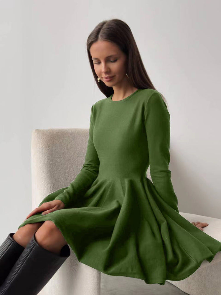 Fitted Knit Skater Mini Dress with Long Sleeves in Moss — seated view on model