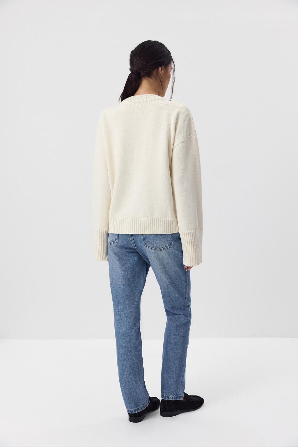 Relaxed Cotton Crew Neck Sweater with Ribbed Cuffs in Ivory — back view on model