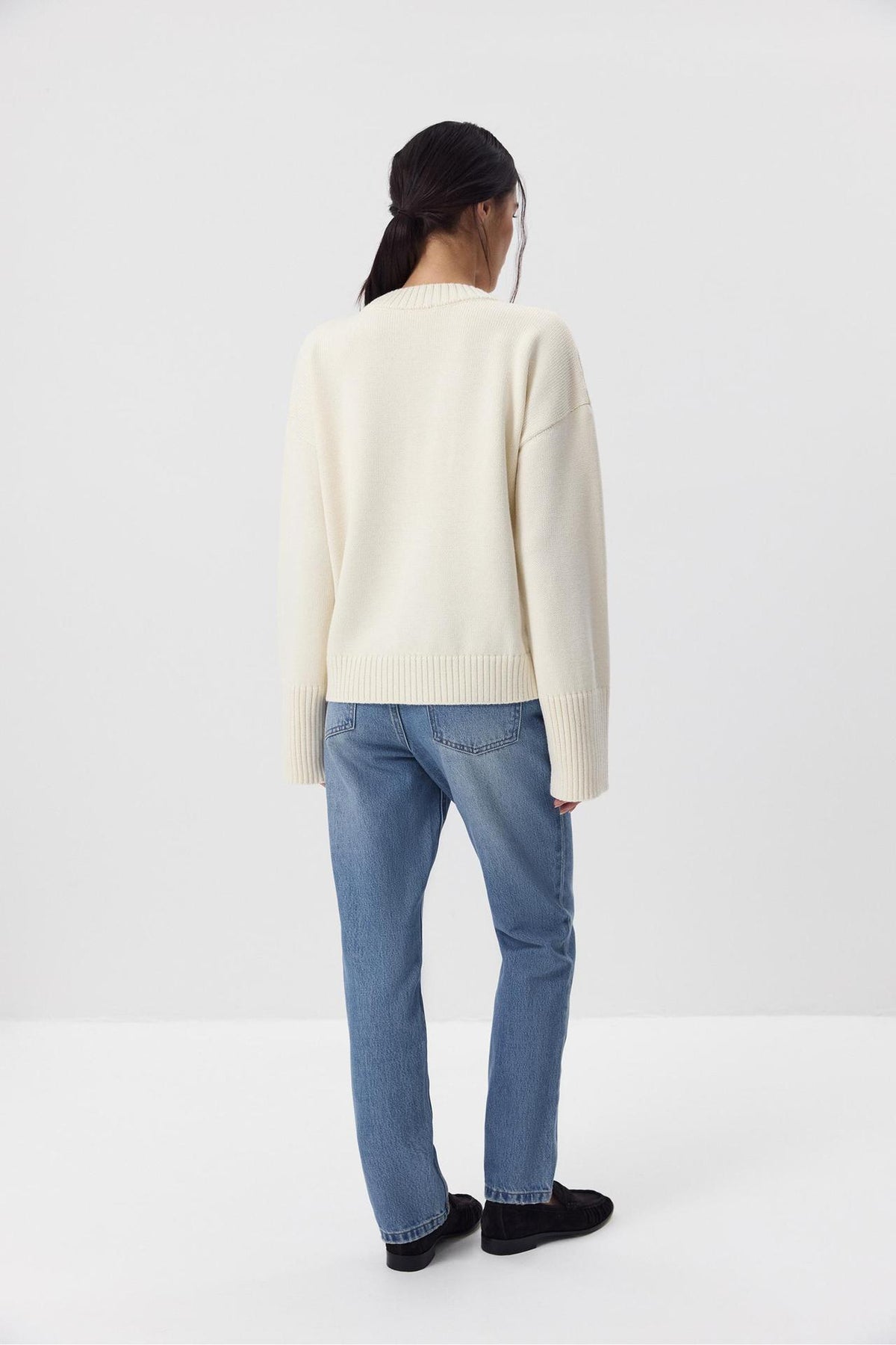 Relaxed Cotton Crew Neck Sweater with Ribbed Cuffs in Ivory — back view on model