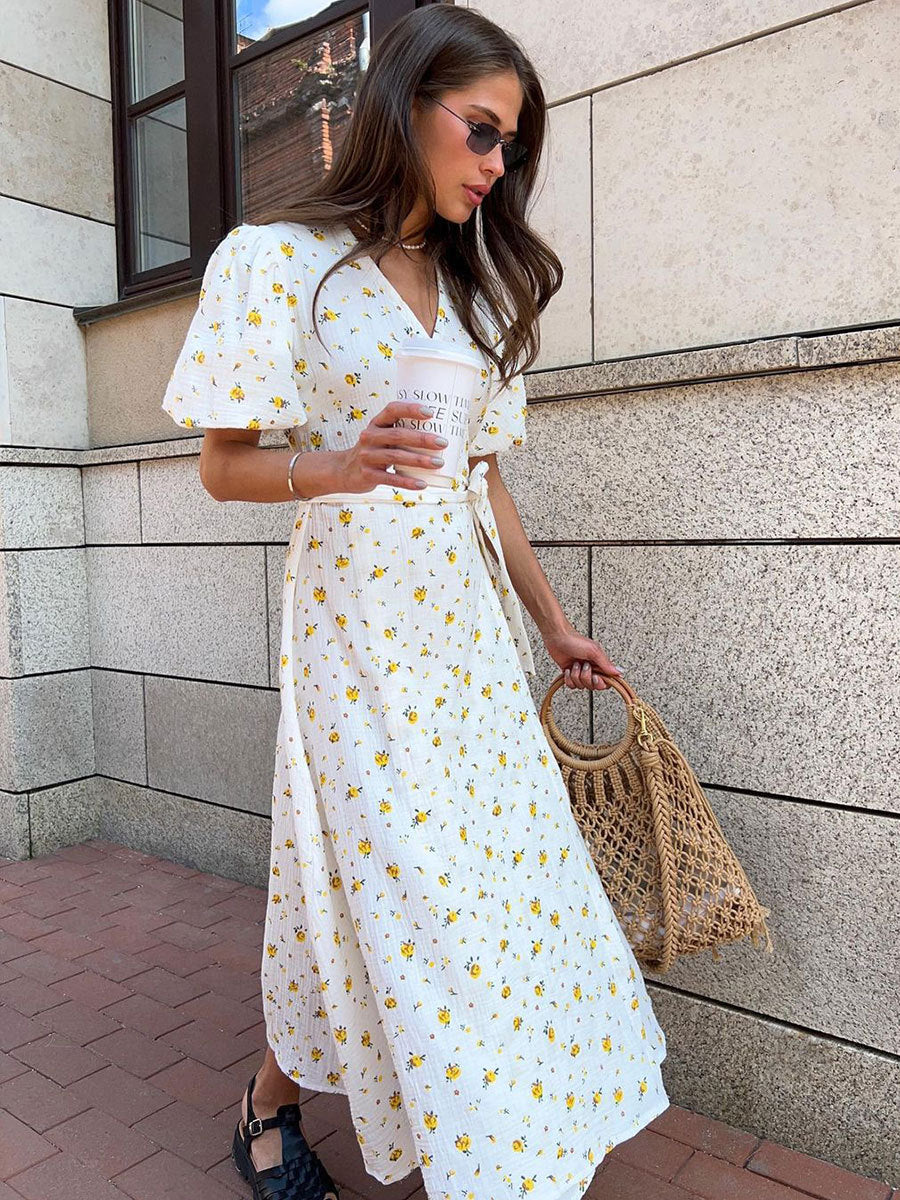 Cotton Floral Puff-Sleeve Wrap Midi Dress in Yellow Floral — front view on model, outdoor