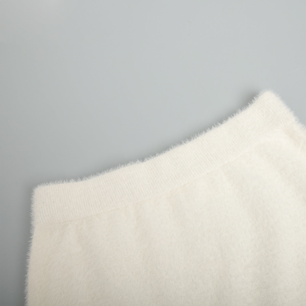 Soft Fuzzy V-Neck Sweater & Knit Maxi Skirt Set in Ivory — close-up of the skirt waistband