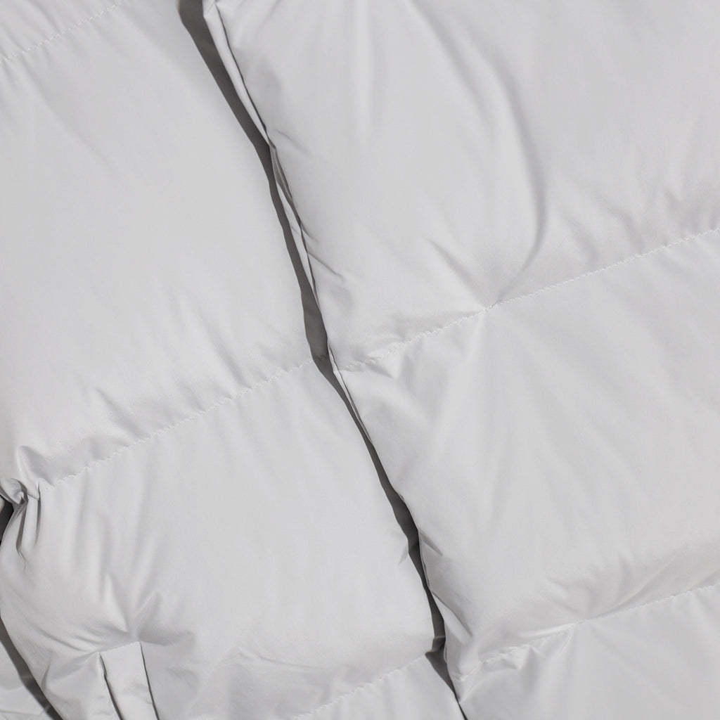 Matte Oversized Hooded Puffer Jacket in Light Gray — close-up of the quilting