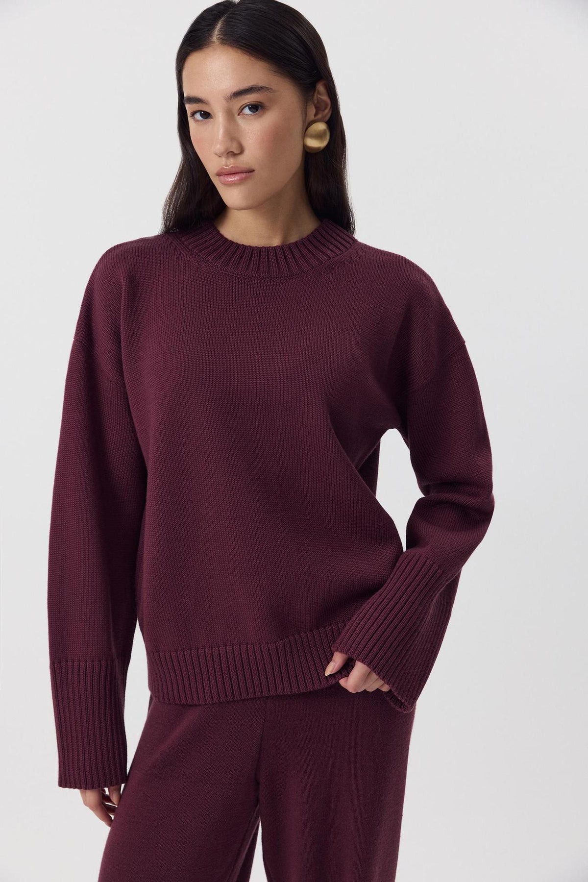 Relaxed Cotton Crew Neck Sweater with Ribbed Cuffs in Burgundy — front view on model