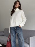 Relaxed High Neck Sweater with Ribbed Cuffs in Ivory — front view on model or garment