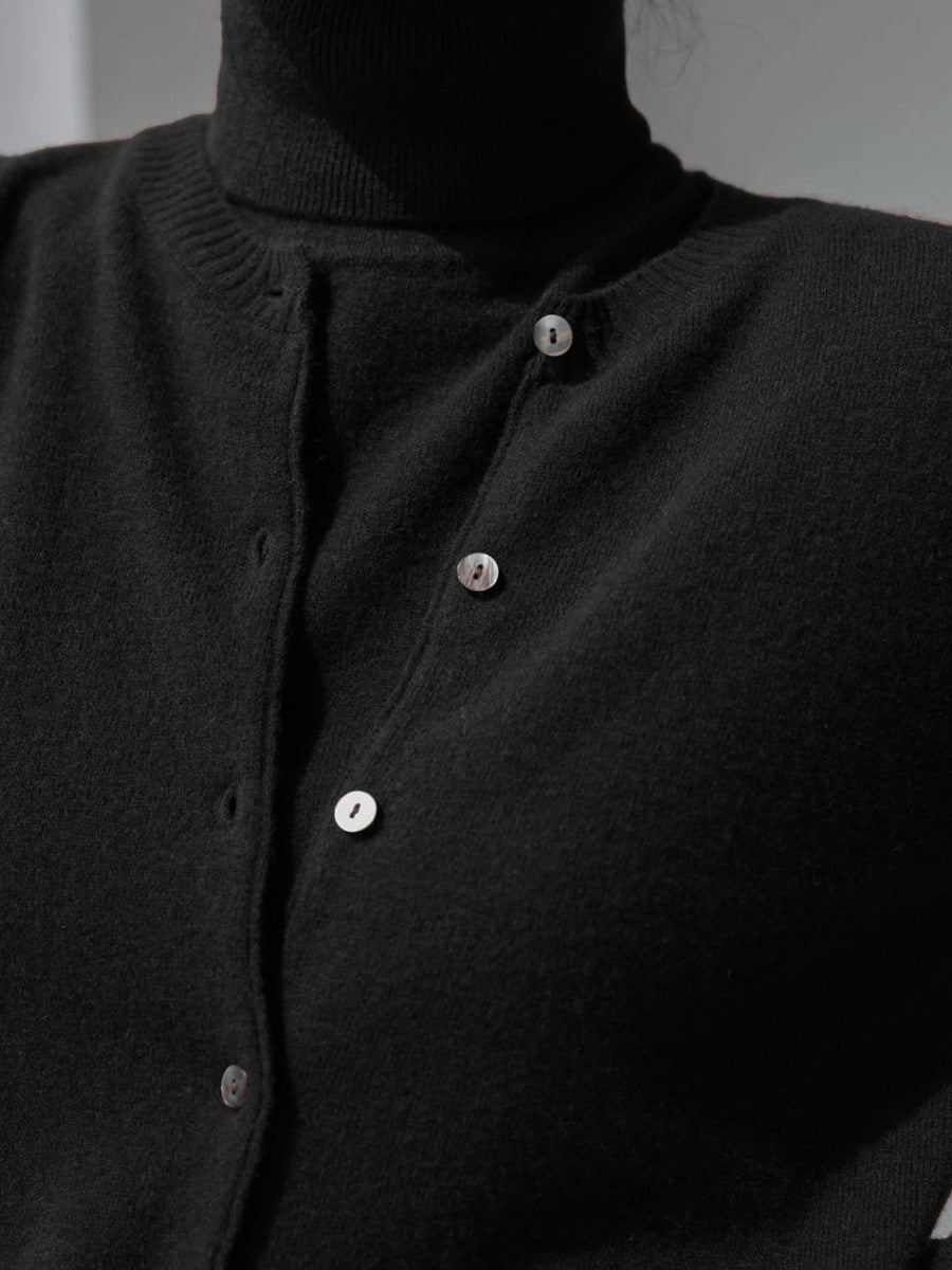 Sleeveless Turtleneck Knit Top & Cardigan Twin Set in Black — close-up of turtleneck and buttons